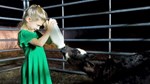 green dress girl feeding calf